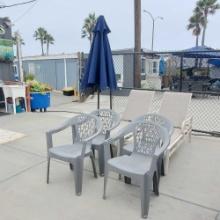 2 reclining lawn chairs 4 grey plastic chairs 1 large umbrella with stand