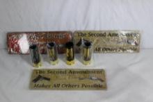 Three metal 10"x 3 1/2" signs and one box of 12 ga shotgun shell shot glasses.