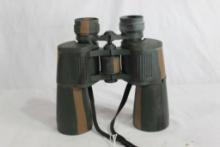 One pair of green camo rubberized binoculars. Used.