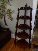CORNER SHELF WITH (5) SHELVES. APPEARS TO BE VERY OLD. SMALL PIECE MISSING ON THE BOTTOM LEFT SHELF.