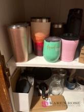 Tumblr cups, and miscellaneous kitchen cabinet next to dishwasher