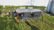BRAND NEW 67â€� x 40â€� Grey Hard Wood Dining Table with Polypropylene All weather Top and (6) Recyc