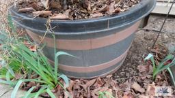 Plastic planter with potting soil. Must take contents