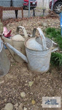 Three large galvanized watering cans