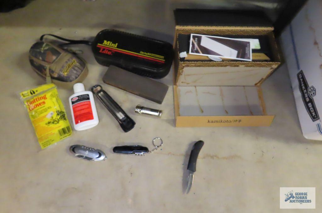 Miscellaneous items including plastic gloves, knives, sharpening blade, mini light, etc