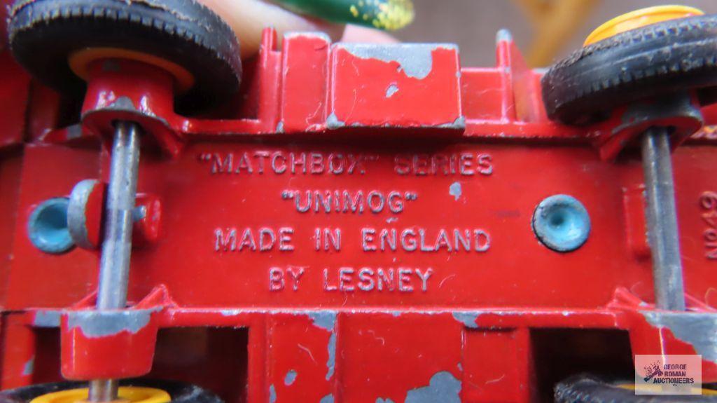 Two red and teal trucks made in England by Lesney, one missing rubber tires