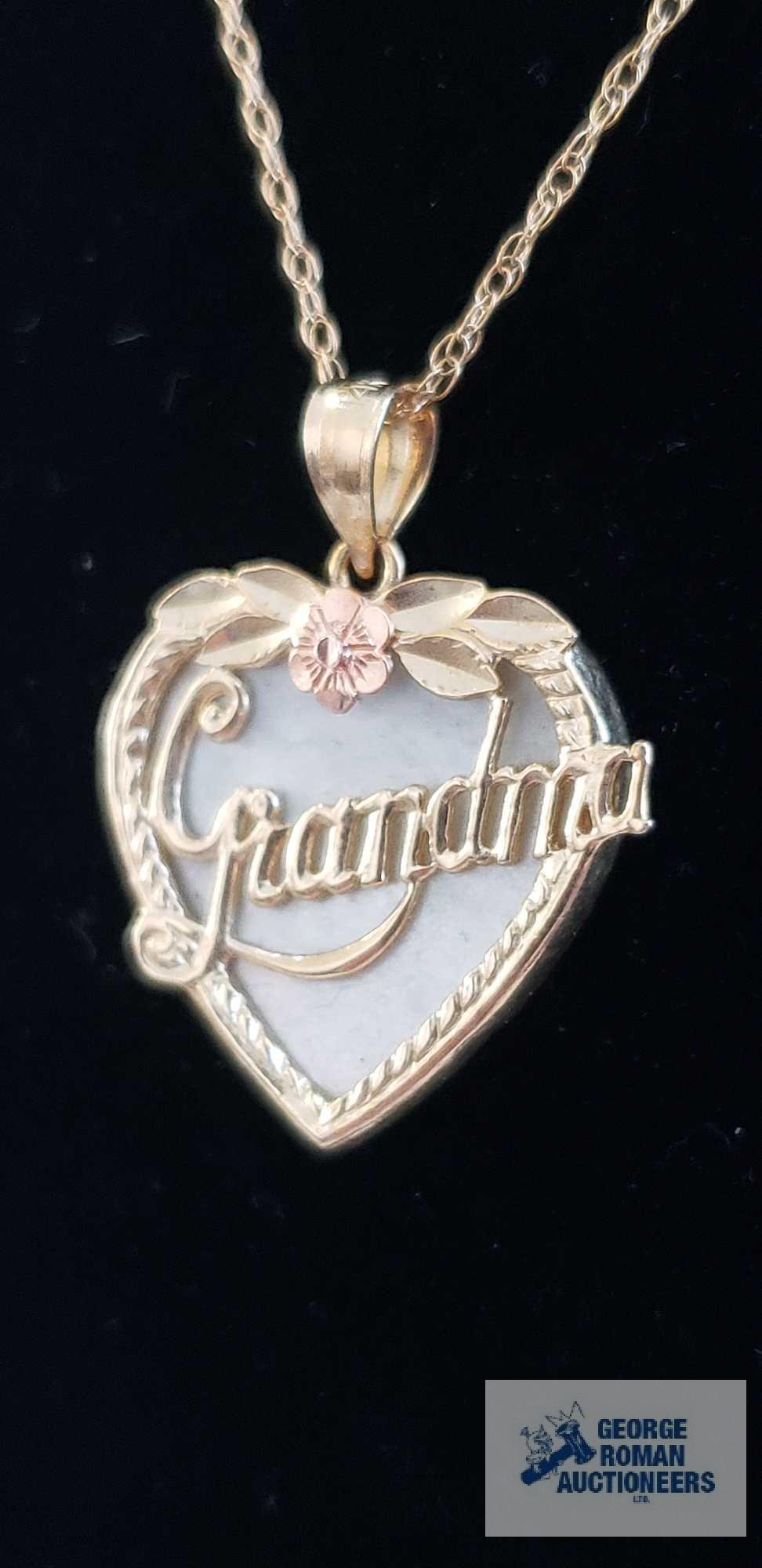 Gold colored Grandma pendant with pink flower and iridescent stone background, marked 14K on gold