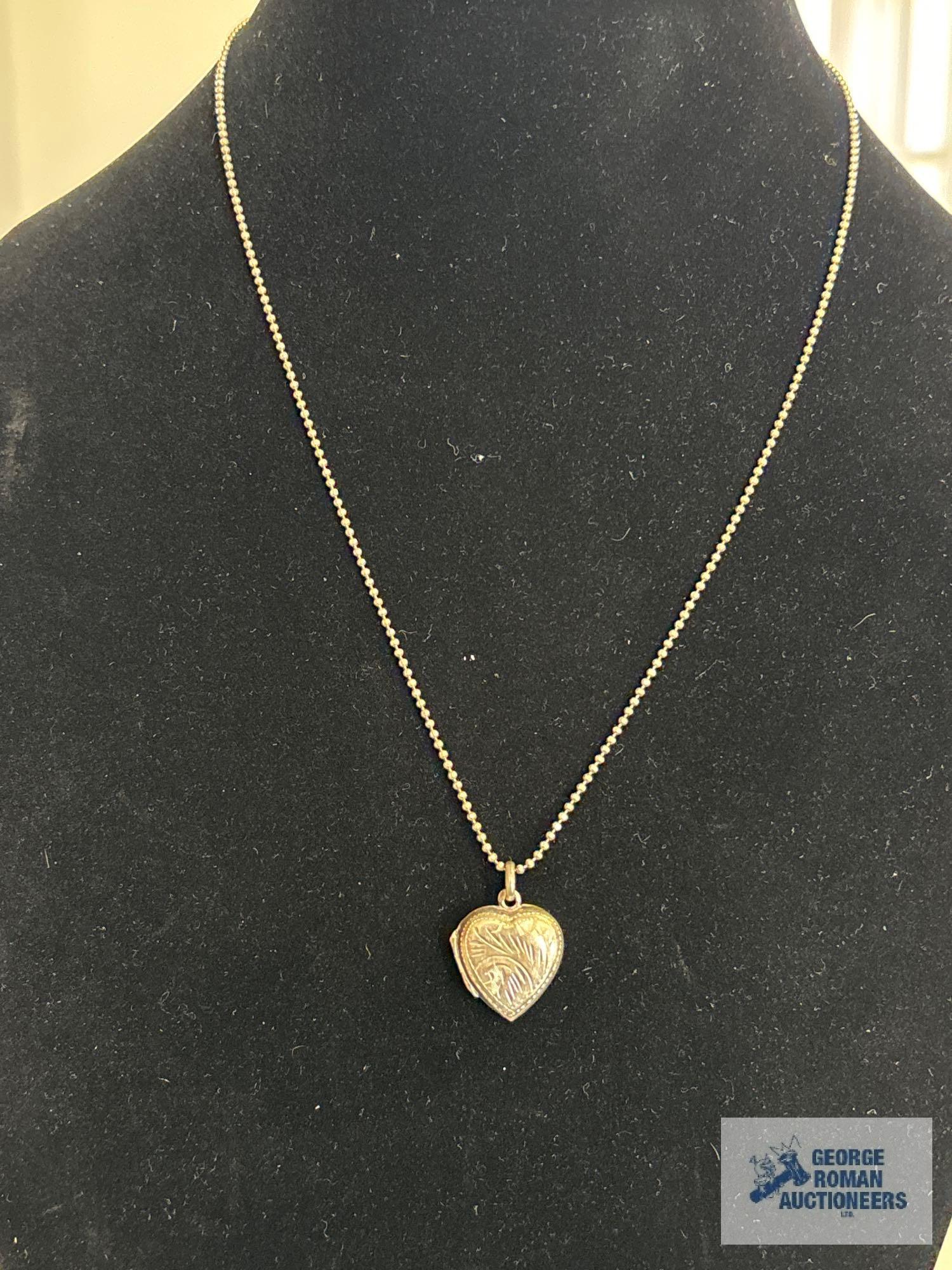 Silver colored heart-shaped locket, marked 925, on silver colored bead like necklace, marked 925