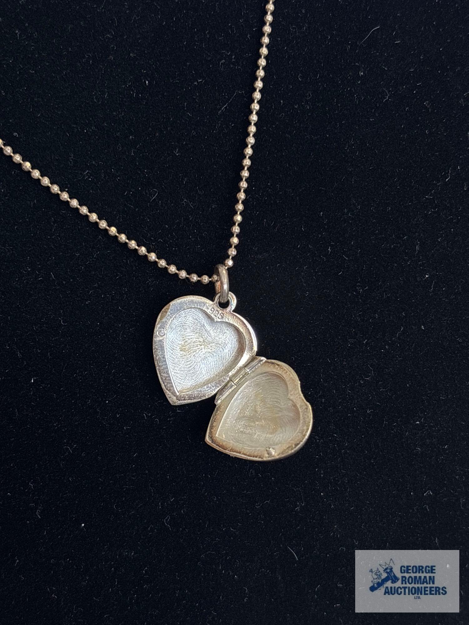 Silver colored heart-shaped locket, marked 925, on silver colored bead like necklace, marked 925