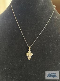 Silver colored cross pendant with clear gemstone chips, marked 925, on silver colored chain, marked