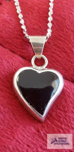 Silver colored heart-shaped pendant with black stone, marked 925 Mexico, on silver color chain,