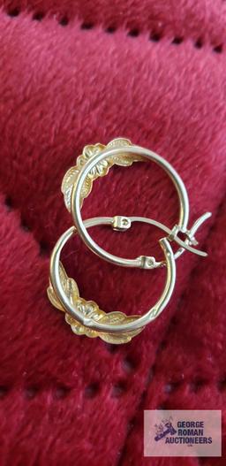 Gold colored floral hoop earrings, marked 10K, approximate total weight is 1.15 G