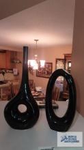 Two decorative black circular ceramic vases