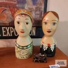 Two wooden doll head figures. One called Madame Dechelles and the other called Anique. Small trimmed