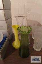 Assortment of vases, including clear. Green. Yellow swirl.