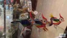 Colorful glass roosters and mom sign