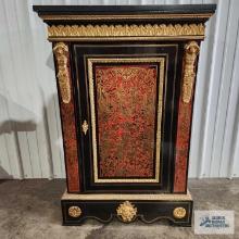 Ornate antique cabinet with gold trim and dimensional figurines. Has original key and marble top.