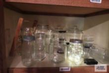 Large assortment of kitchen glassware including Pyrex measuring cup, butter dish, refrigerator