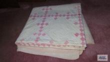 Embroidered pink and white quilt