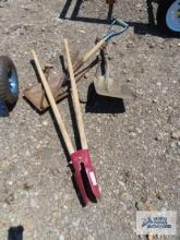 Yard and garden tools including post hole digger, crowbars, and shovels