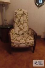 Green and cream colored armchair with wooden frame