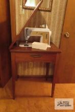 Vintage Singer sewing machine with cabinet and accessories