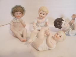 Seven Vintage Bisque Piano Baby Figurines