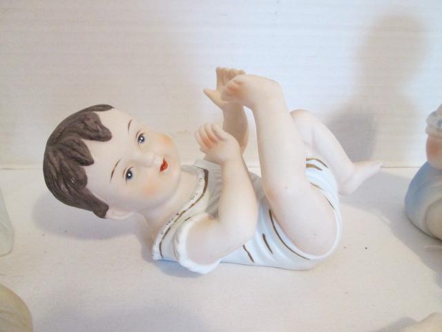 Seven Vintage Bisque Piano Baby Figurines