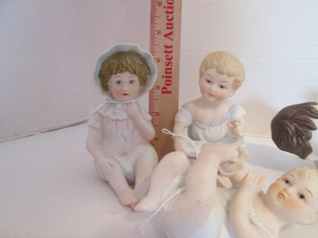 Seven Vintage Bisque Piano Baby Figurines