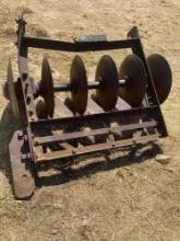 Antique bottom plow, used as yard art.
