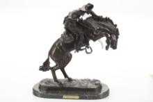 Bronze Western Sculpture titled "Wooly Chaps", marked "Copyright Frederick Remington". Bronze measur