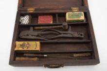 Early wooden fitted Box that contains two early iron bullet molds, small wooden mallet, 5-piece clea