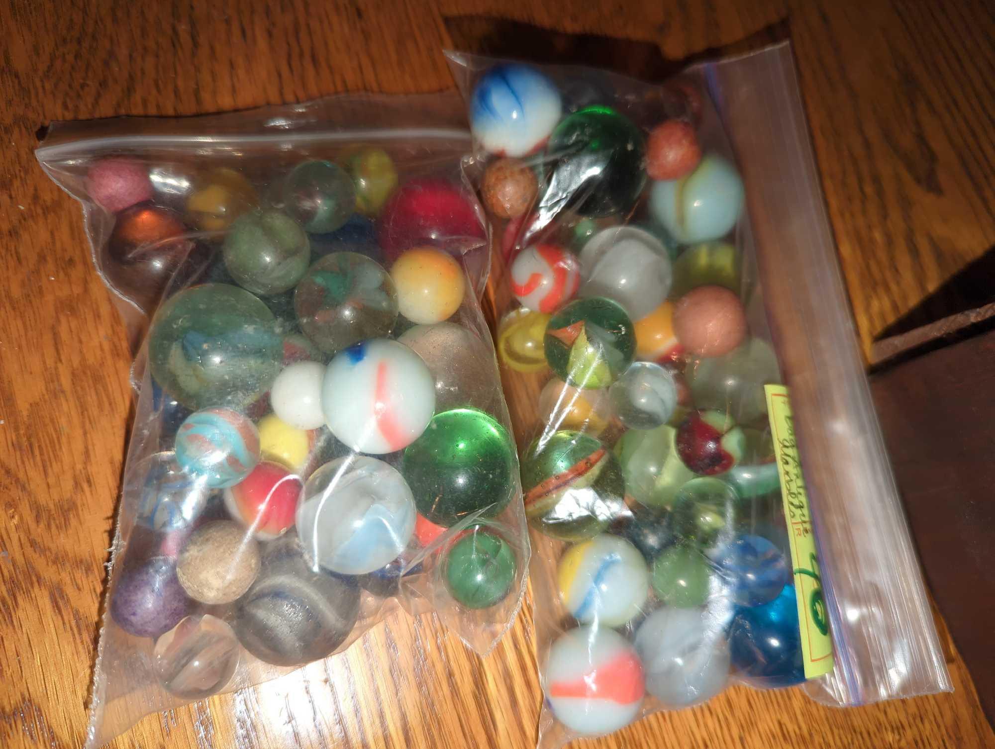 (DR) LOT OF ASSORTED CONTAINERS CONTAINING ASSORTED TYPES OF MARBLES, WHAT YOU SEE IN THE PHOTOS IS