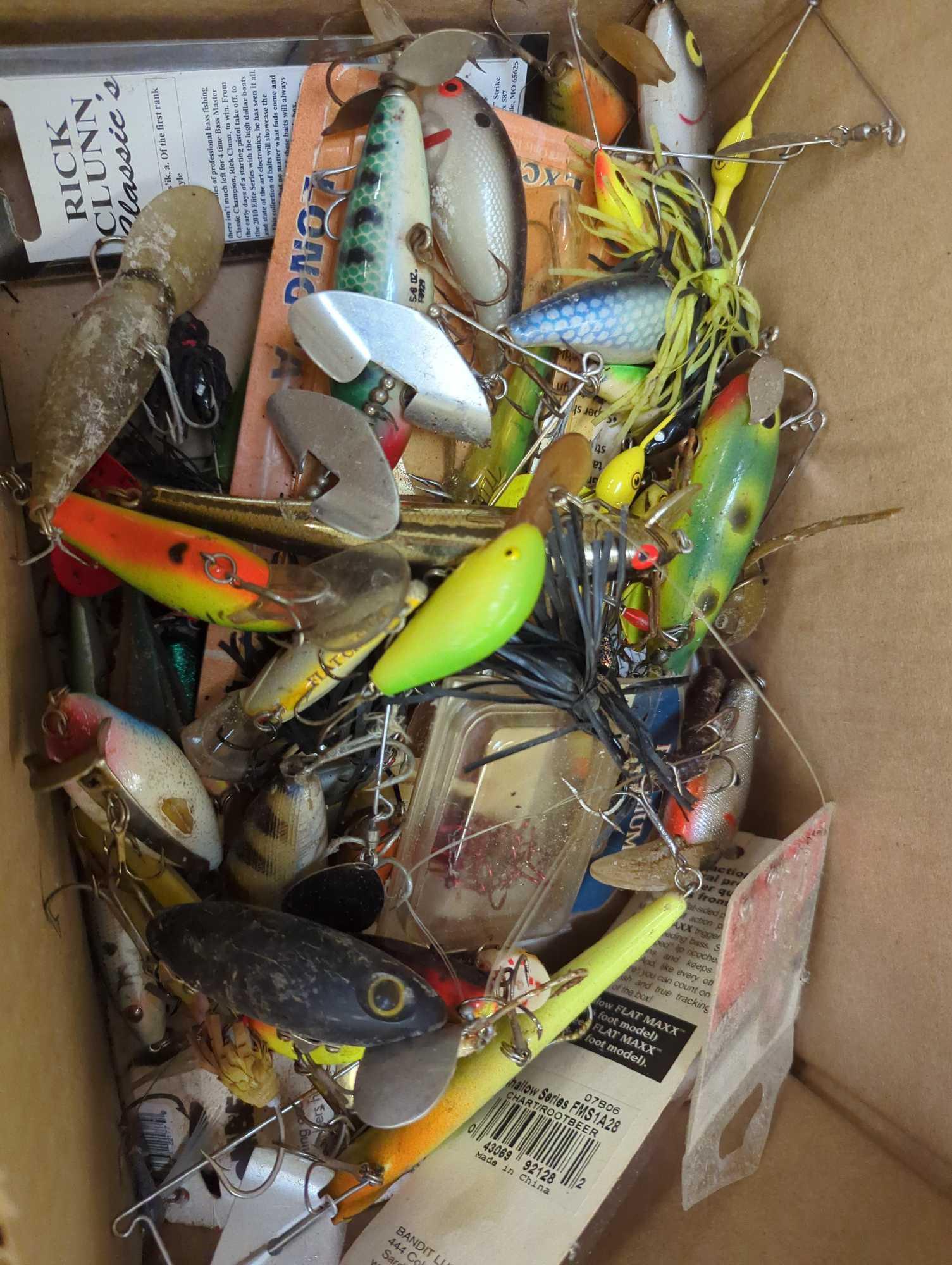 Box of various fishing lures and other fishing accessories. Comes as is shown in photos. Appears to