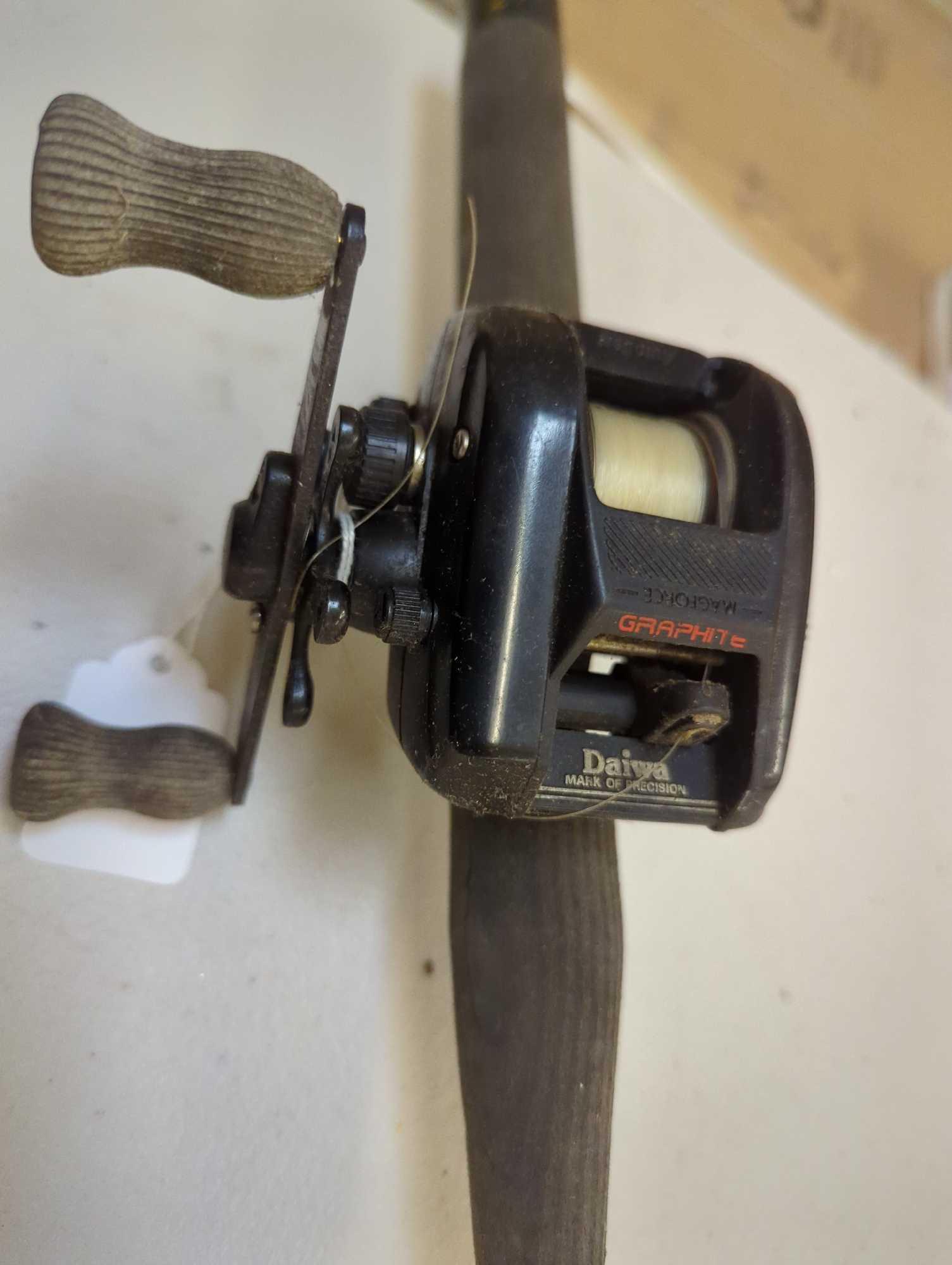 Black 6' fishing rod with Daiwa fishing reel. Comes as is shown in photos. Appears to be used.