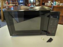 Magic Chef 0.7 cu. ft. 700-Watt Countertop Microwave in Black. It comes in open box. Appears to be