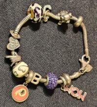 Sterling Silver charm bracelet. Has a Redskins charm on it. Marked 925. Measures 7.5" long.