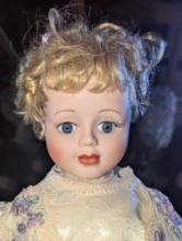 (GAR) Blonde Haired and Blue Eyed Porcelain Doll Wearing a White Wedding Dress with Lace on Front