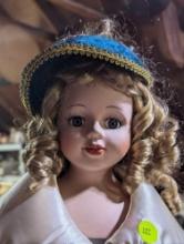 (GAR) Blonde Haired and Blue Eyed Porcelain Doll Wearing a Teal Dress with Gold and Cream Accents,