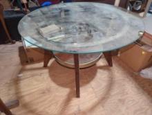 (GAR) ROUND GLASS TOP COFFEE TABLE WITH WOOD LEGS AND BOTTOM SHELF, TOP DOES COME OFF MEASURE