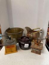 Two coffee grinders, brass and copper pots and a crock with lid and two handles