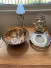 Bowl with glass ornaments, two clocks, and a candle lamp