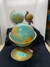Three vintage globes in various sizes