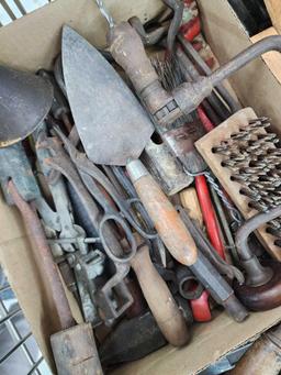 Cart full of vintage tools: hatchets, saws, wrenches, metal detector