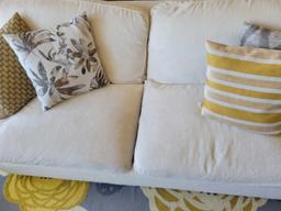 Clean light color 2 cushion sofa with accent pillows
