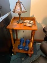 Wooden side table with lamp and dumbbells
