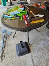 Patio table, umbrella stand, bags, misc