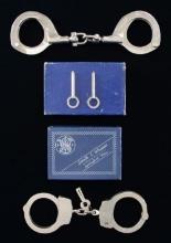 2 PAIRS OF HANDCUFFS BY S&W AND H&R.