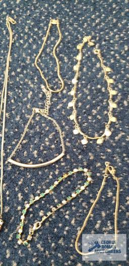 Costume jewelry gold colored bracelets and necklaces, some have colored...gemstones