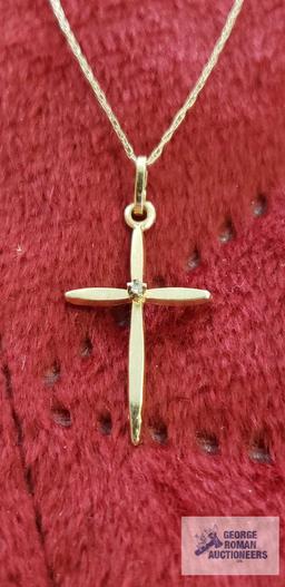 Gold colored cross with clear gemstone chip, marked 14K on gold colored necklace, marked 10K,